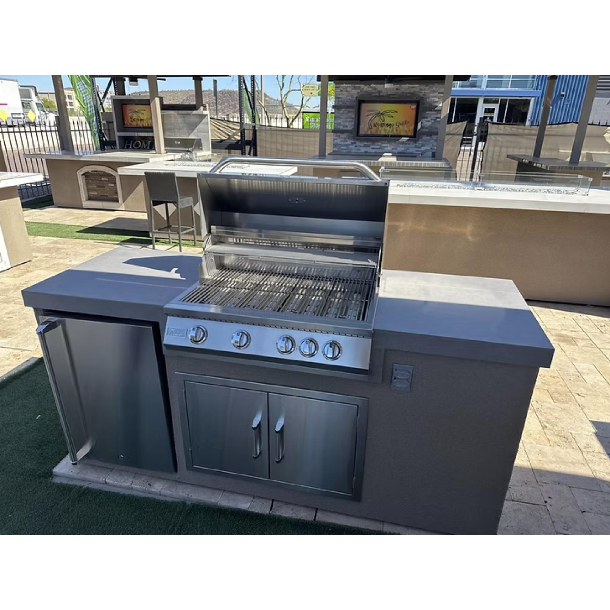 Stainless steel outdoor grill with cabinets on a patio